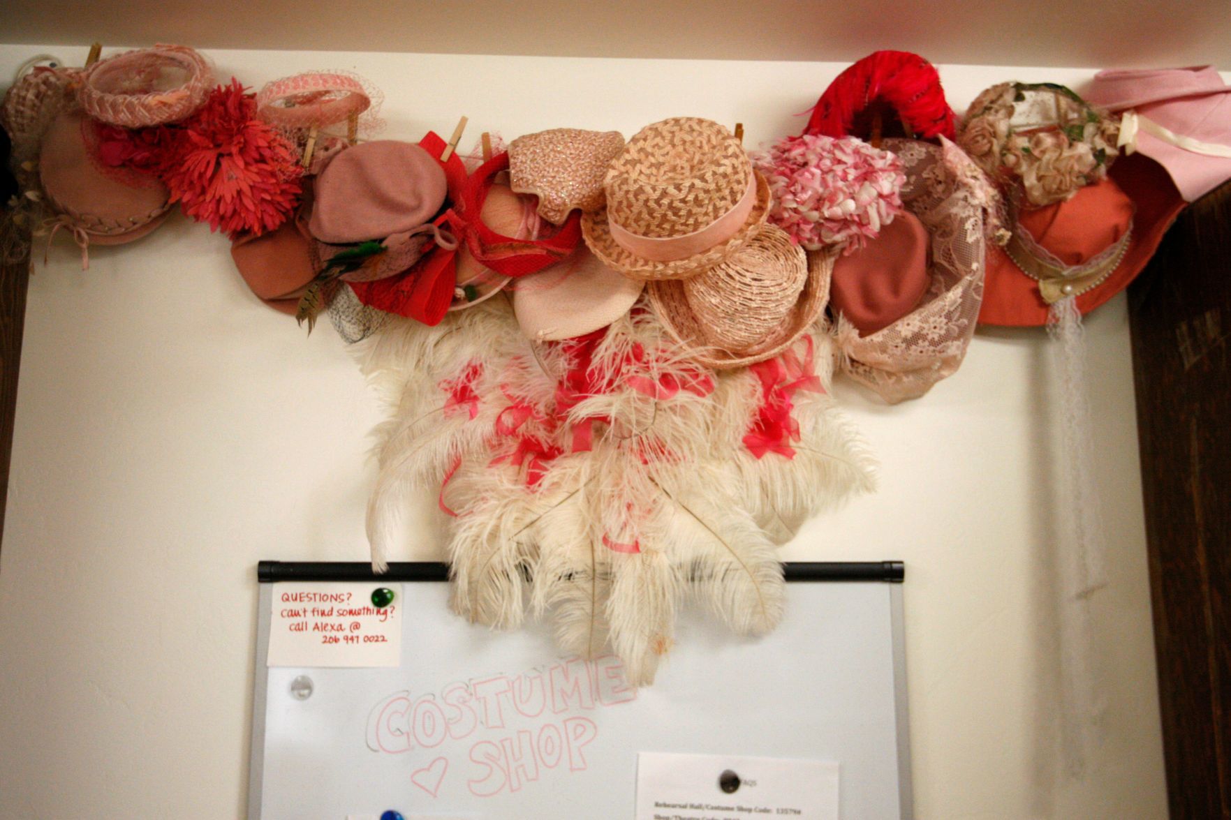Hats are hung by color in the costume shop